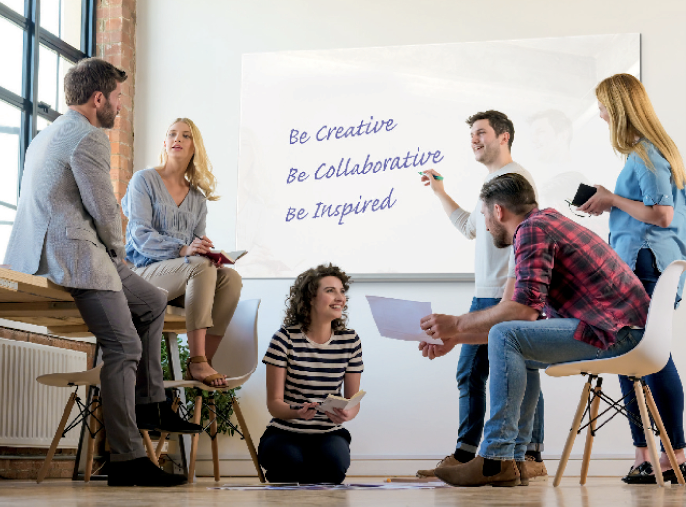 Breakout session in the office around a whiteboard